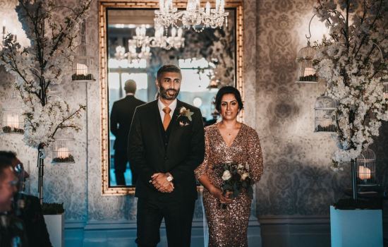 Bride-and-Groom-stood-in-front-of-River-Room-mirror